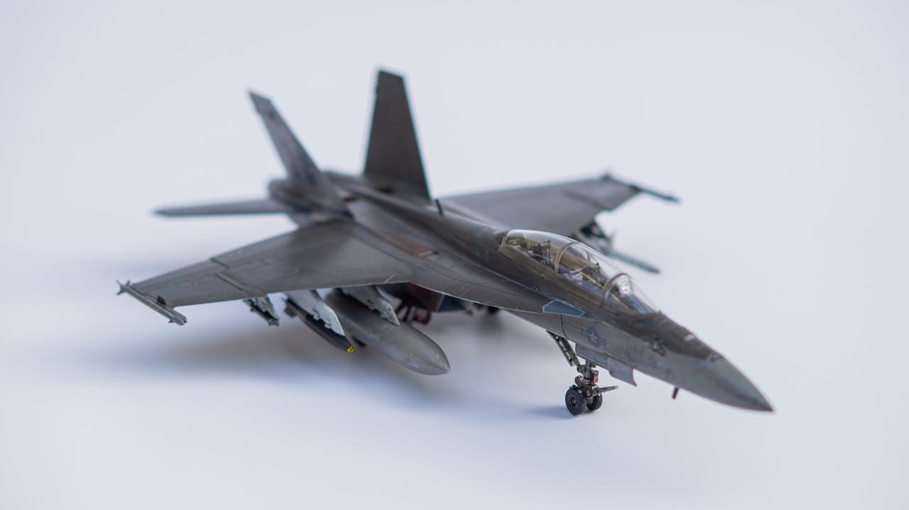 Detailed miniature of an F/A-18 jet model showcasing intricate design against a white backdrop.